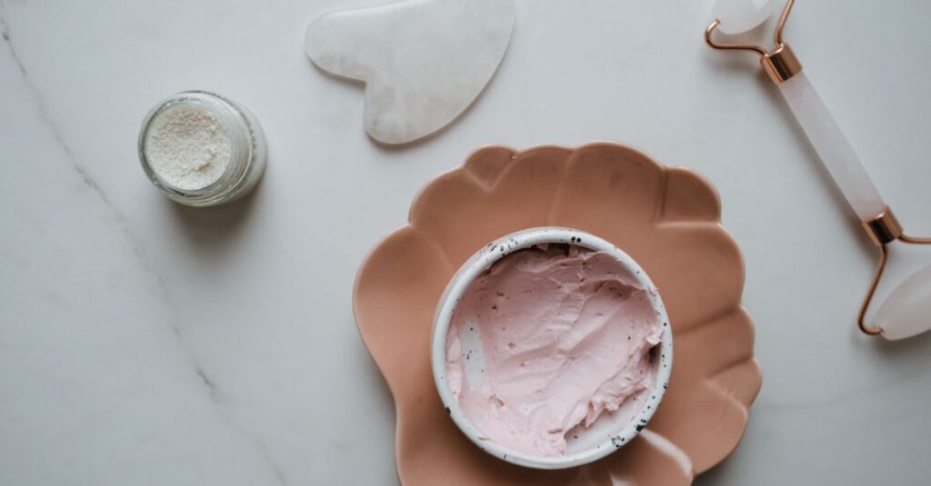 10 Home Remedies for Glowing Skin Elegant top view of skincare essentials including cream, gua sha, and roller on marble surface, perfect for beauty concepts.